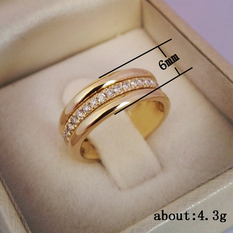 Gold ring with diamond accents in a box, showing size and weight measurements.
