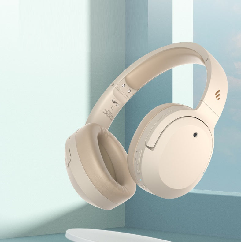 Beige headphones on a light blue background