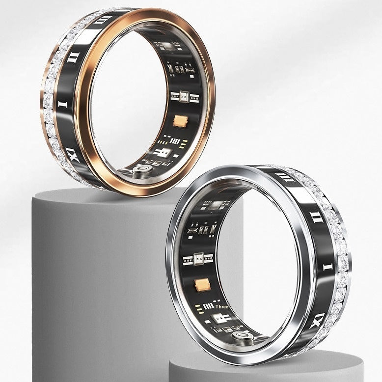 Two rings with digital displays on a gray pedestal against a white background