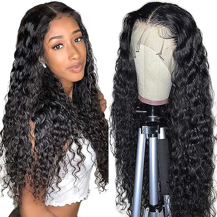 Woman with long curly hair next to a wig on a mannequin head.